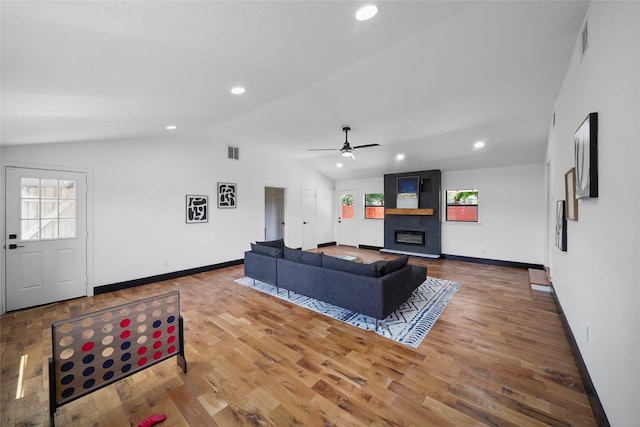 701 W 39th St, Houston, TX 77018 - living area with vaulted ceiling, healthy amount of natural light, ceiling fan, baseboards, and a fireplace