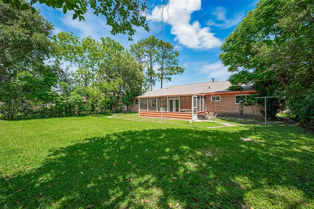 12206 Ashcroft Dr, Houston, TX 77035 - rear view of house with a sunroom, brick siding, and french doors