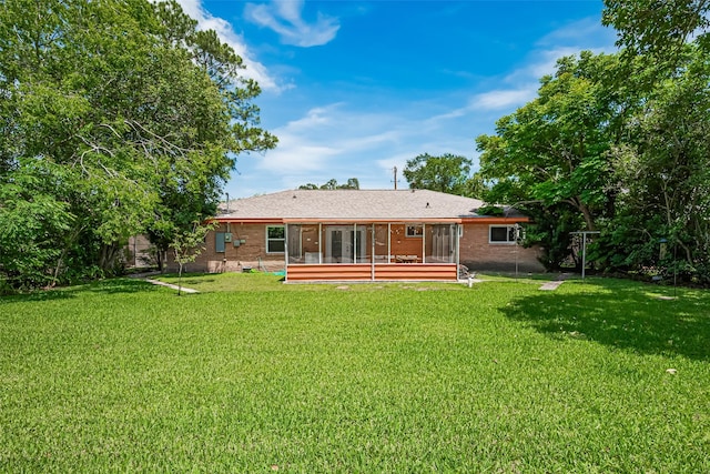 12206 Ashcroft Dr, Houston, TX 77035 - rear view of property featuring a yard, a sunroom, brick siding, and french doors