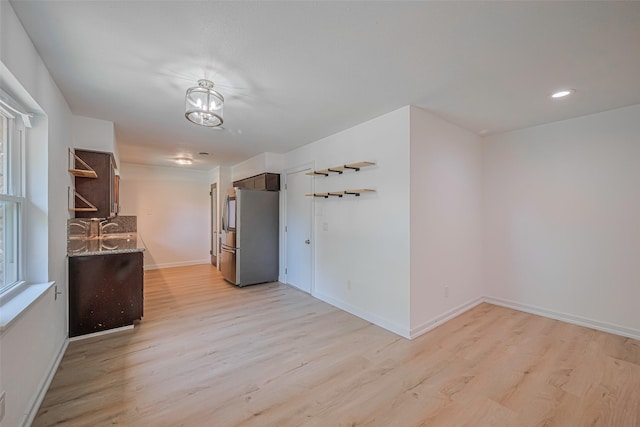 12206 Ashcroft Dr, Houston, TX 77035 - spare room featuring light wood-type flooring, baseboards, a sink, a chandelier, and recessed lighting