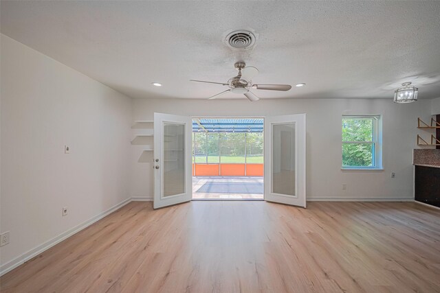 12206 Ashcroft Dr, Houston, TX 77035 - unfurnished living room featuring light wood finished floors, ceiling fan, baseboards, recessed lighting, and a textured ceiling