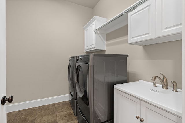 4215 Orchard Arbor Ln, Sugar Land, TX 77479 - laundry room featuring independent washer and dryer, cabinet space, and baseboards