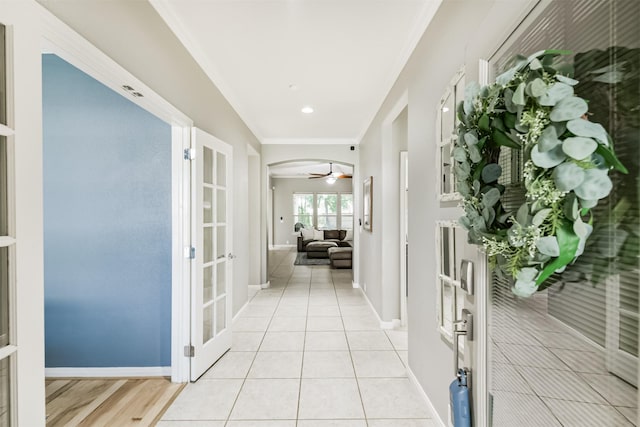 16802 Cherokee Lake Ln, Houston, TX 77044 - hallway featuring french doors, ornamental molding, baseboards, and light tile patterned floors