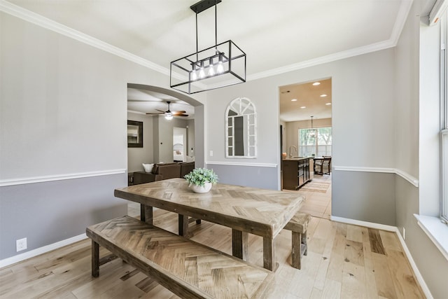 16802 Cherokee Lake Ln, Houston, TX 77044 - dining space featuring ceiling fan, a chandelier, arched walkways, light wood-style flooring, and baseboards