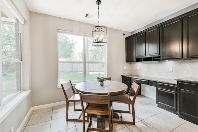 16802 Cherokee Lake Ln, Houston, TX 77044 - dining space with a chandelier, baseboards, and light tile patterned flooring