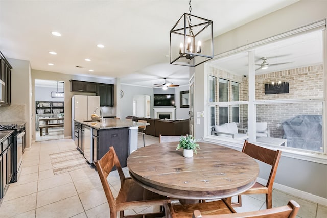 16802 Cherokee Lake Ln, Houston, TX 77044 - dining space with a ceiling fan, light tile patterned floors, a fireplace, recessed lighting, and baseboards
