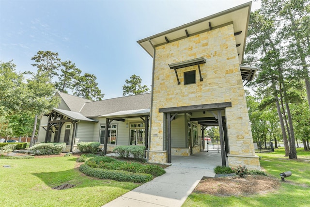16802 Cherokee Lake Ln, Houston, TX 77044 - view of front facade featuring stone siding and a front lawn