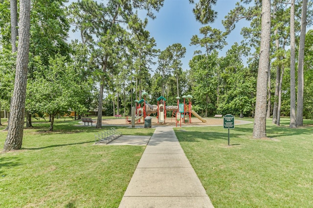 16802 Cherokee Lake Ln, Houston, TX 77044 - community jungle gym with a lawn and view of wooded area