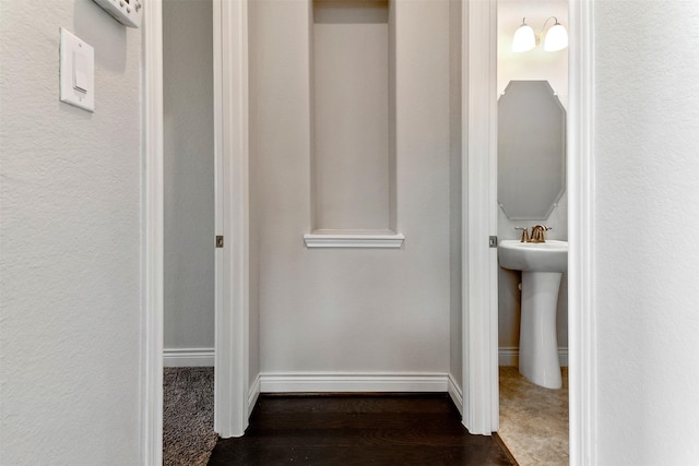 4926 Thunder Creek Ln, Sugar Land, TX 77479 - corridor with dark wood-style flooring, a sink, and baseboards