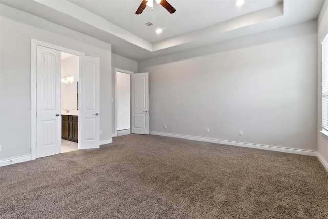 4926 Thunder Creek Ln, Sugar Land, TX 77479 - unfurnished bedroom with a raised ceiling, light carpet, baseboards, ensuite bathroom, and recessed lighting