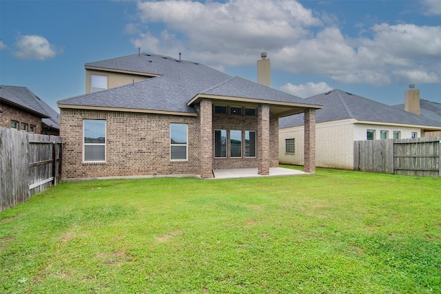 4926 Thunder Creek Ln, Sugar Land, TX 77479 - back of house featuring a patio area, brick siding, a shingled roof, and a chimney