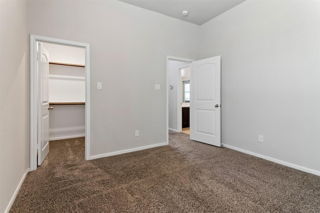 4926 Thunder Creek Ln, Sugar Land, TX 77479 - unfurnished bedroom with a walk in closet, carpet, baseboards, and a closet
