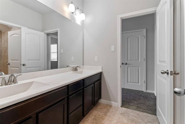 4926 Thunder Creek Ln, Sugar Land, TX 77479 - bathroom featuring double vanity, tile patterned floors, and baseboards