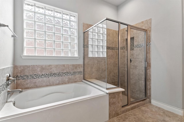 4926 Thunder Creek Ln, Sugar Land, TX 77479 - bathroom featuring a garden tub, a shower stall, and tile patterned flooring