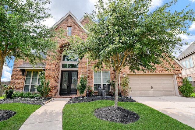 29016 Concan Crossing Ct, Katy, TX 77494 - view of front facade featuring french doors, brick siding, driveway, and a front yard