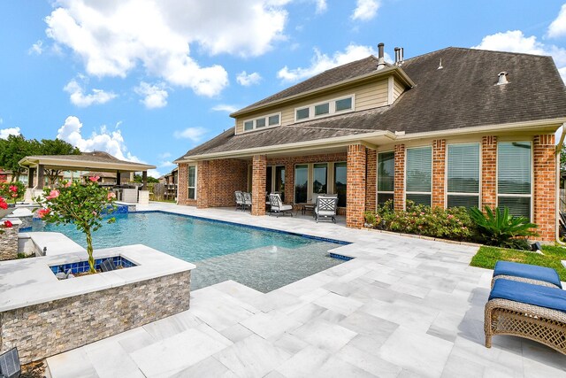29016 Concan Crossing Ct, Katy, TX 77494 - view of pool featuring a fire pit, a patio, a pool with connected hot tub, and exterior bar