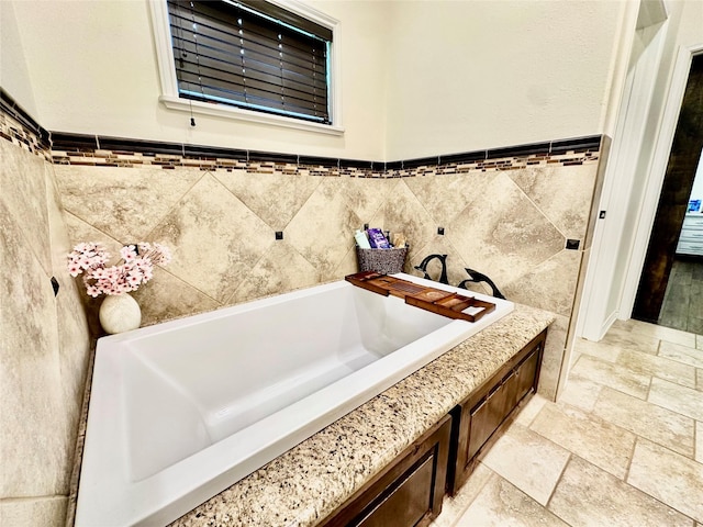 4815 Fm 2827th Rd, Warren, TX 77664 - full bath featuring tile walls, a bath, stone tile flooring, and wainscoting