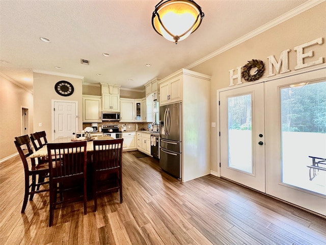 4815 Fm 2827th Rd, Warren, TX 77664 - dining space with ornamental molding, wood finished floors, french doors, and baseboards