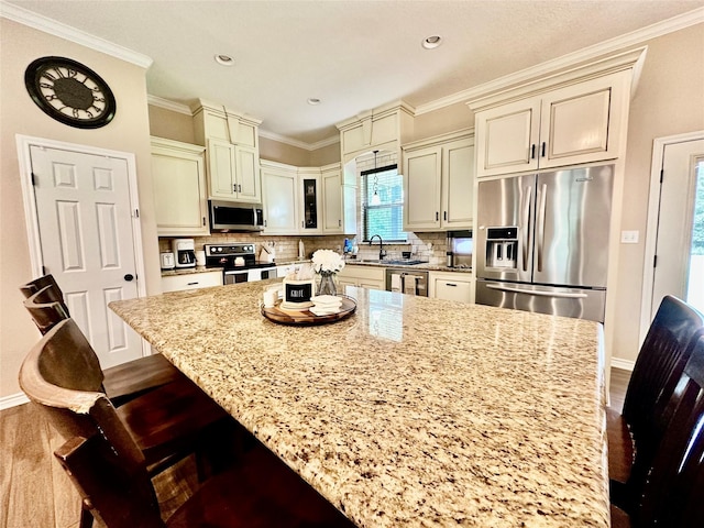 4815 Fm 2827th Rd, Warren, TX 77664 - kitchen featuring stainless steel appliances, cream cabinetry, light stone countertops, dark wood-style floors, and decorative backsplash