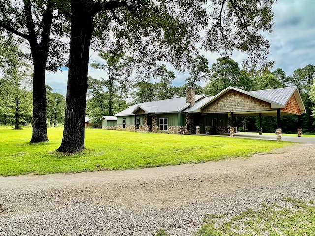 4815 Fm 2827th Rd, Warren, TX 77664 - view of front facade featuring gravel driveway, a chimney, a front yard, and metal roof