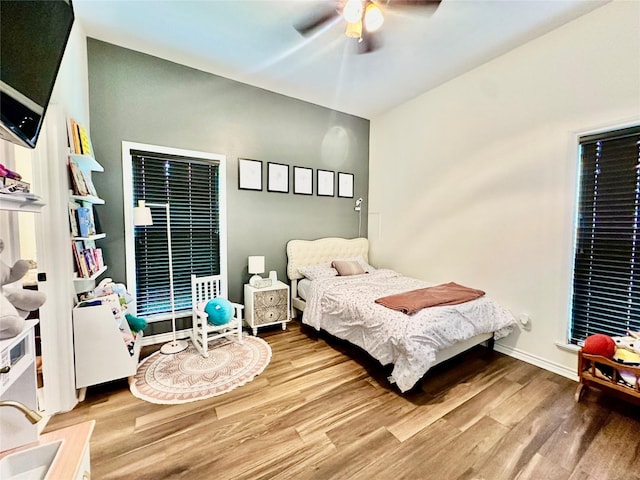 4815 Fm 2827th Rd, Warren, TX 77664 - bedroom featuring wood finished floors, a ceiling fan, and baseboards