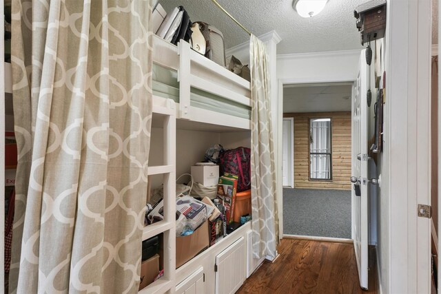 6102 Seawall Blvd Unit 271, Galveston, TX 77551 - bedroom with dark wood finished floors, crown molding, and a textured ceiling