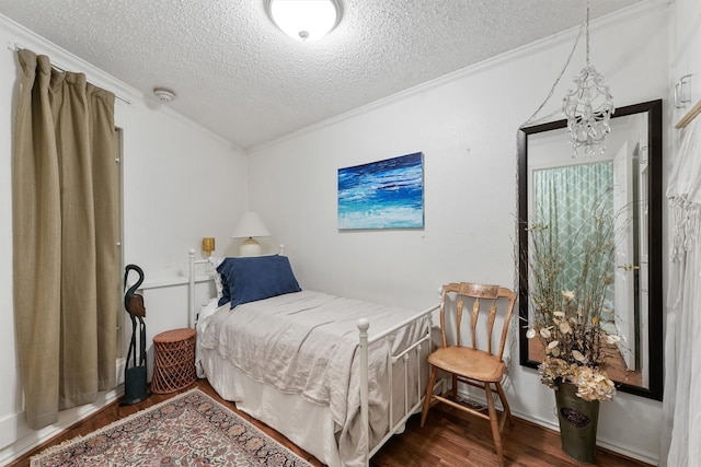 6102 Seawall Blvd Unit 271, Galveston, TX 77551 - bedroom featuring ornamental molding, a textured ceiling, wood finished floors, and a chandelier