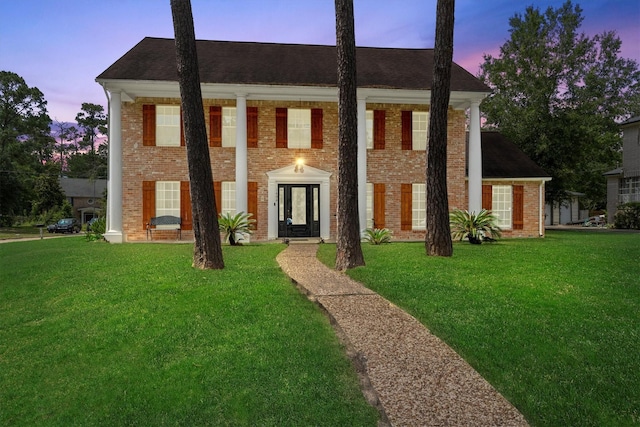 1406 Grand Valley Dr, Houston, TX 77090 - greek revival house with a front yard and brick siding