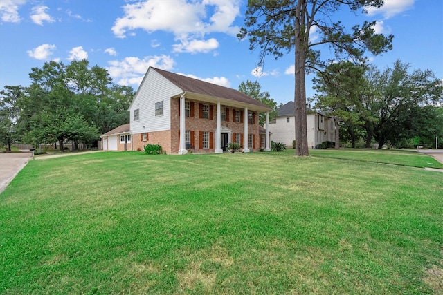 1406 Grand Valley Dr, Houston, TX 77090 - neoclassical / greek revival house with brick siding, a front lawn, and a garage