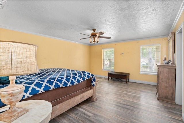 1406 Grand Valley Dr, Houston, TX 77090 - bedroom with wood finished floors, a textured ceiling, ornamental molding, baseboards, and ceiling fan