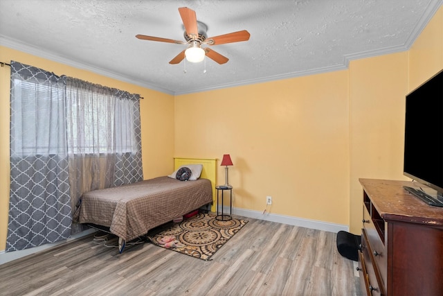1406 Grand Valley Dr, Houston, TX 77090 - bedroom featuring wood finished floors, crown molding, a textured ceiling, baseboards, and ceiling fan