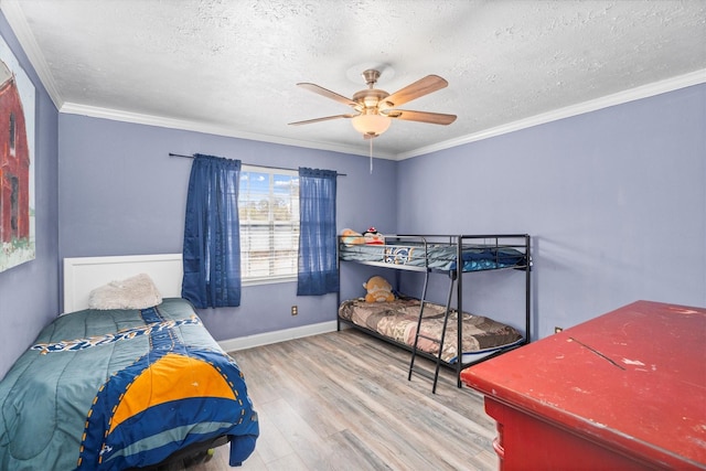 1406 Grand Valley Dr, Houston, TX 77090 - bedroom featuring wood finished floors, a textured ceiling, baseboards, crown molding, and a ceiling fan