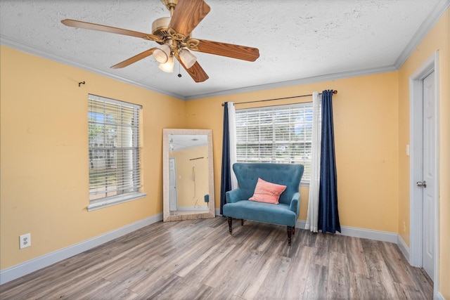 1406 Grand Valley Dr, Houston, TX 77090 - living area with crown molding, a textured ceiling, wood finished floors, baseboards, and a ceiling fan