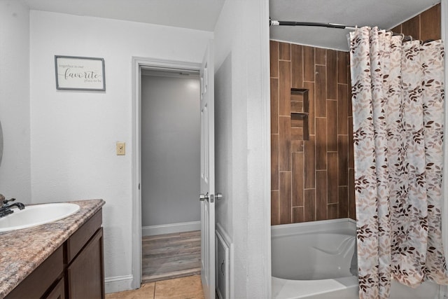 1406 Grand Valley Dr, Houston, TX 77090 - bathroom featuring vanity, shower / bath combo with shower curtain, tile patterned floors, and baseboards