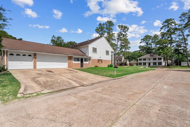 1406 Grand Valley Dr, Houston, TX 77090 - view of front facade with brick siding, concrete driveway, a garage, and a front yard