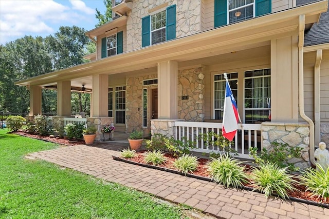 7419 Lorna Rd, Montgomery, TX 77316 - view of exterior entry featuring a porch, stone siding, and a yard