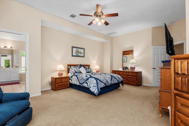 7419 Lorna Rd, Montgomery, TX 77316 - bedroom featuring light colored carpet, baseboards, ensuite bath, and ceiling fan