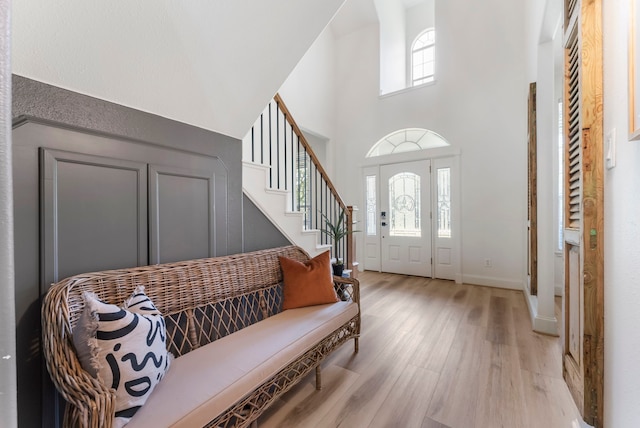 3714 Falun Ct, Spring, TX 77386 - entryway with light wood-type flooring, a high ceiling, baseboards, and stairs
