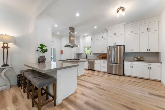 3714 Falun Ct, Spring, TX 77386 - kitchen featuring appliances with stainless steel finishes, island range hood, a peninsula, decorative backsplash, and crown molding