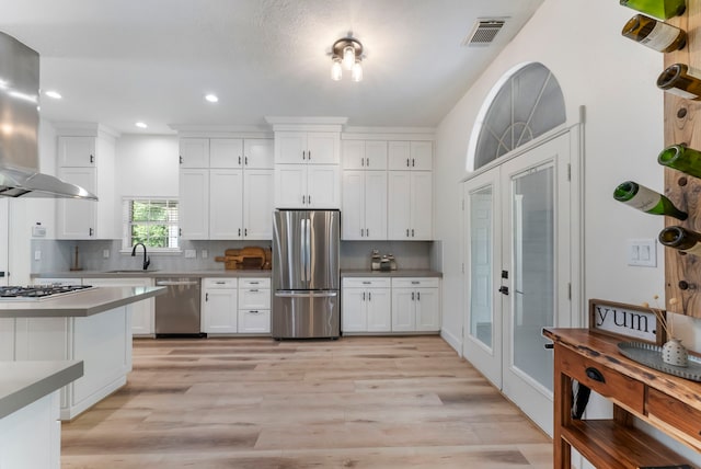 3714 Falun Ct, Spring, TX 77386 - kitchen with appliances with stainless steel finishes, island exhaust hood, a sink, recessed lighting, and white cabinets