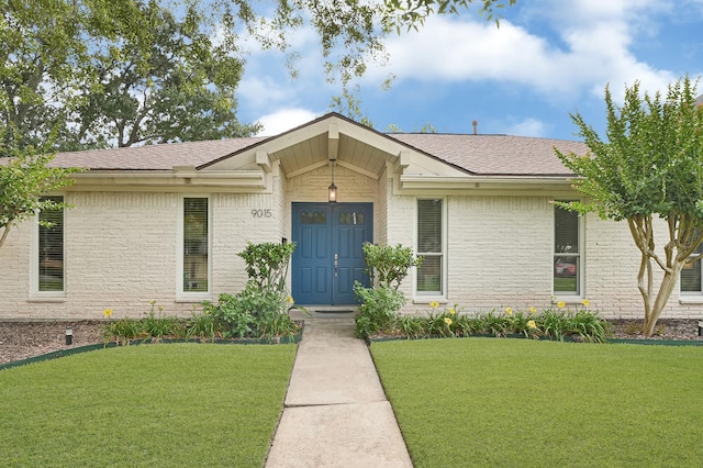 9015 Landsdowne Dr, Houston, TX 77096 - view of front of home featuring brick siding, a front lawn, and a shingled roof