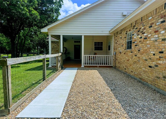 22035 Buescher Rd, Tomball, TX 77377 - property entrance with brick siding and a porch