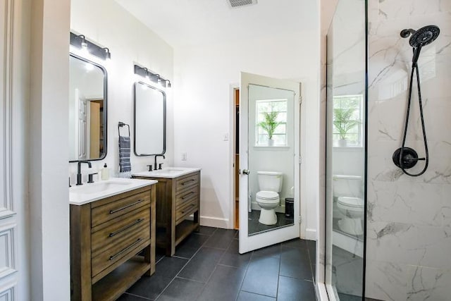 22035 Buescher Rd, Tomball, TX 77377 - bathroom with toilet, a marble finish shower, two vanities, tile patterned floors, and baseboards