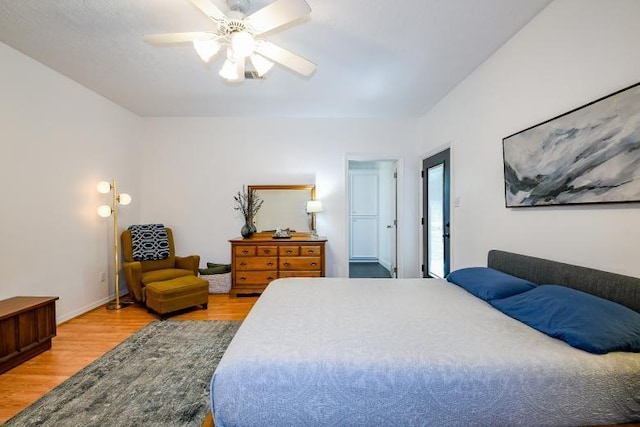22035 Buescher Rd, Tomball, TX 77377 - bedroom featuring wood finished floors, a ceiling fan, and baseboards