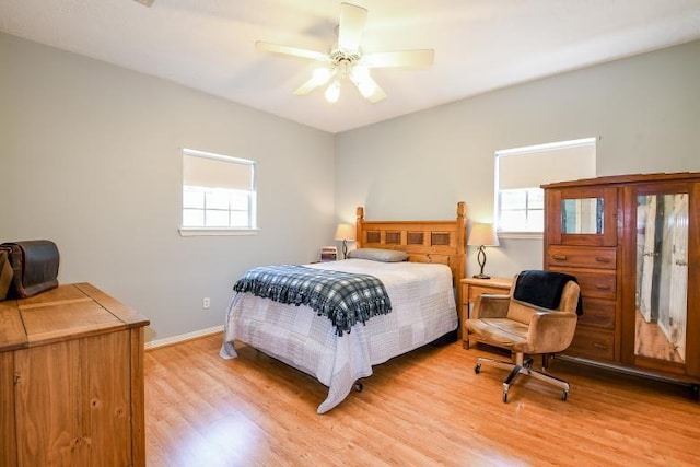 22035 Buescher Rd, Tomball, TX 77377 - bedroom featuring light wood-type flooring, multiple windows, baseboards, and ceiling fan