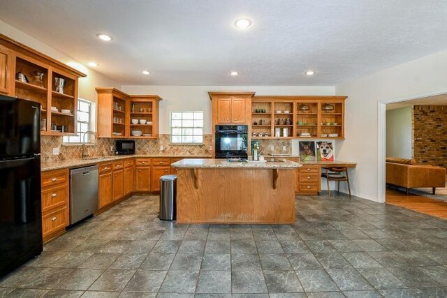 22035 Buescher Rd, Tomball, TX 77377 - kitchen with open shelves, black appliances, light stone counters, backsplash, and recessed lighting