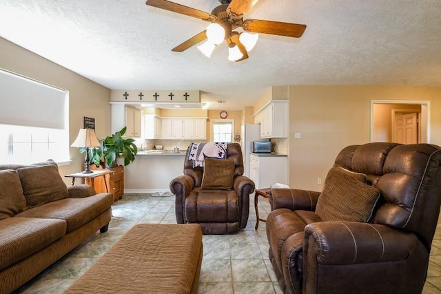 22035 Buescher Rd, Tomball, TX 77377 - living area with ceiling fan, a textured ceiling, and light tile patterned floors
