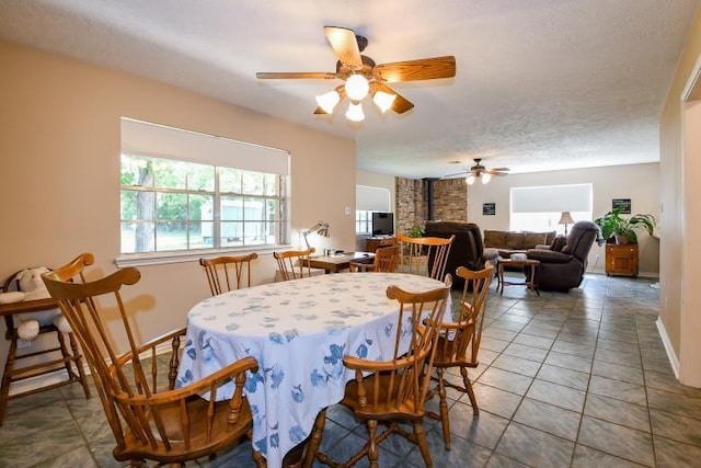 22035 Buescher Rd, Tomball, TX 77377 - dining area with ceiling fan, a textured ceiling, and baseboards
