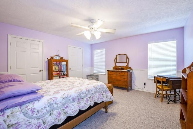 22035 Buescher Rd, Tomball, TX 77377 - bedroom featuring wainscoting, light carpet, ceiling fan, and a closet