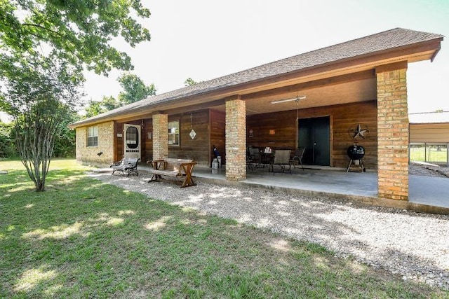 22035 Buescher Rd, Tomball, TX 77377 - rear view of house with a yard